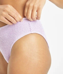 The Swim Ruched High Waist Bikini Bottom: Lilac -Livery Store 4 on model side1 swim ruched high waist bikini bottom lilac