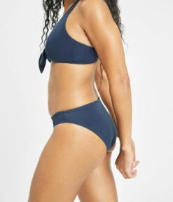 The Bralette & Bikini Swim Bundle: Navy -Livery Store 6 on model side swim plunge bralette navy 715bd950 23e5 42a8 8eb9 97105ea27784
